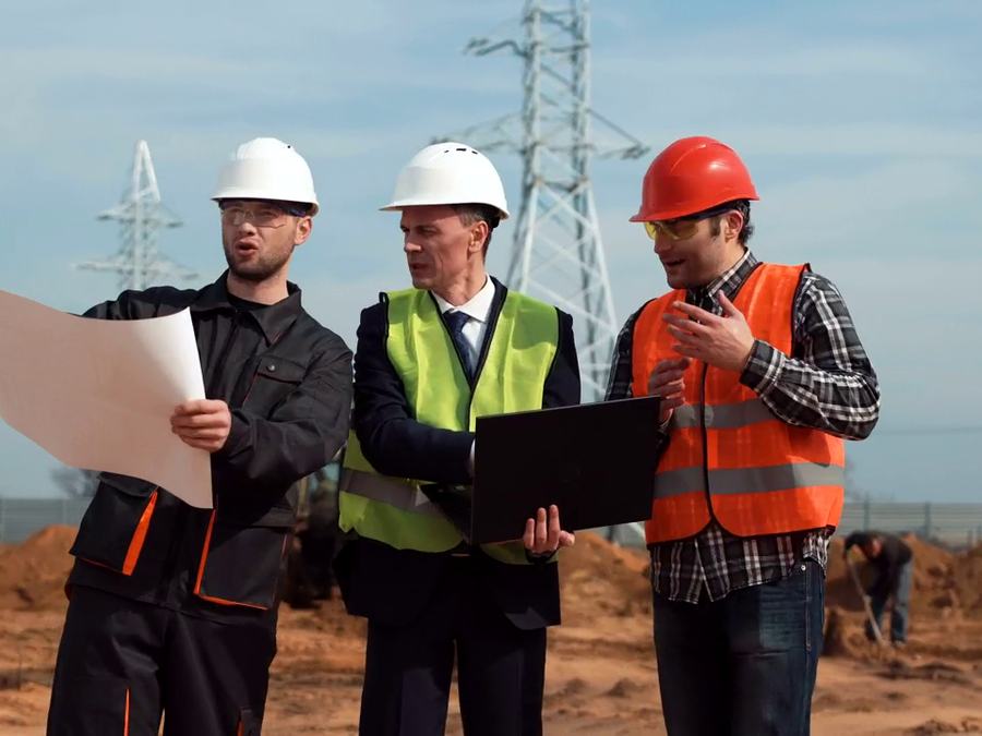 Engineers reviewing plans at a transmission line